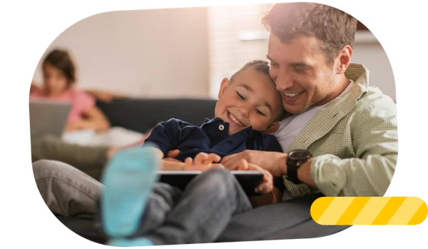 Father and child playing together with a tablet.